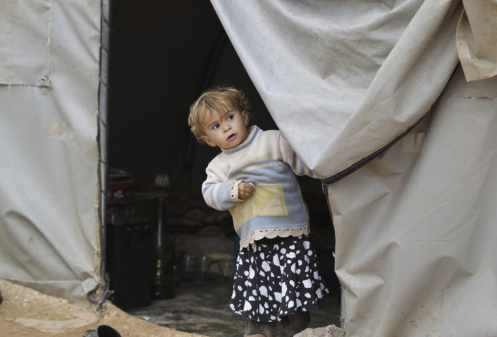 A negotiated end to Syria crisis might allow this child to go back home. Khalil Ashawi:Reuters