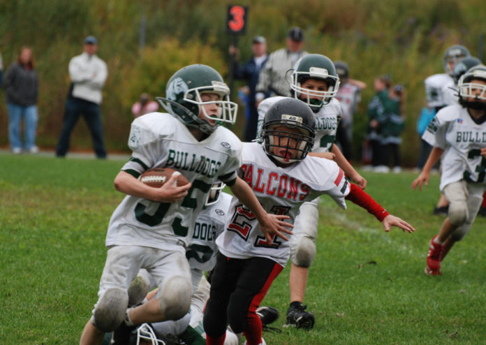 At the youth level, the long-term effects of football hits aren’t known. Brian J. McDermott:flickr, CC BY