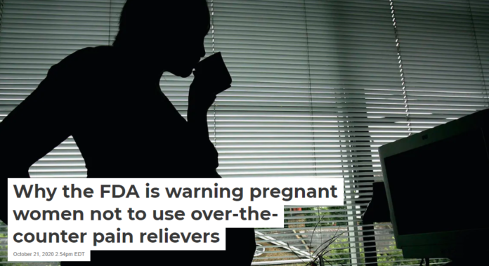 A pregnant woman stands in front of her work station. Daniel Berehulak/Getty Images