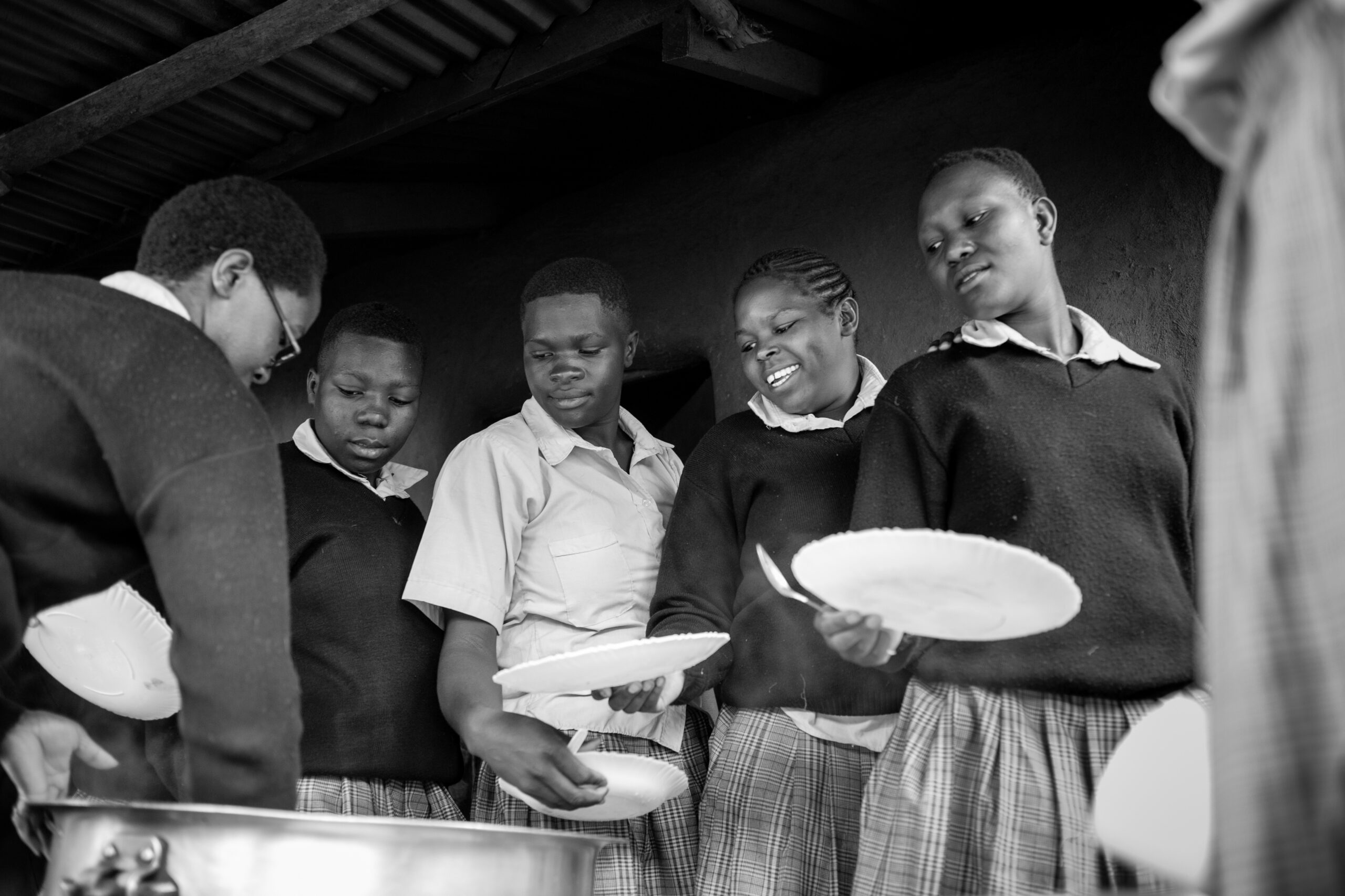 Food being served to young women of the Neema Project