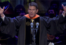 Keith Krach with his hands up at the Perdue Commencement