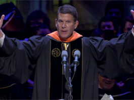 Keith Krach with his hands up at the Perdue Commencement