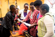 The Silver Lining For A Small Non-Profit – How shifts during the Covid-19 pandemic led to long term changes A group of young women in the Neema Project work together building various skillsets