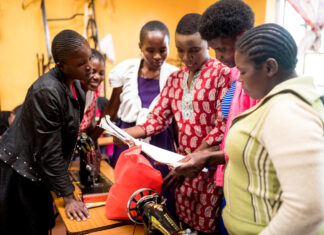 A group of young women in the Neema Project work together building various skillsets