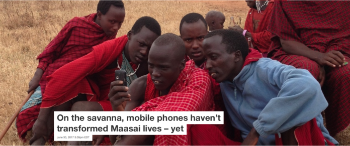 A group of Maasai men look at the mobile phone belonging to one of them. Timothy Baird, CC BY-ND