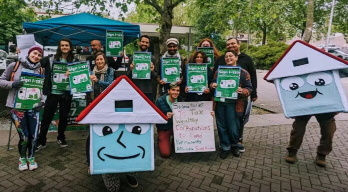 Activists in Seattle gather signatures to put a social housing initiative on the ballot. In early 2025, voters passed the measure, which implements a payroll tax on high incomes to fund the program. House Our Neighbors, CC BY-SA
