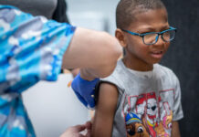 Xerius Jackson, age 7, gets an MMR vaccine during the Texas measles outbreak in March 2025. Jan Sonnenmair via Getty Images