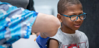 Xerius Jackson, age 7, gets an MMR vaccine during the Texas measles outbreak in March 2025. Jan Sonnenmair via Getty Images