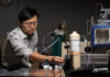Prof. Jie Huang stands with the MOF-based breathalyzer his lab developed with support from the NIH. Michael Pierce/Missouri S&T