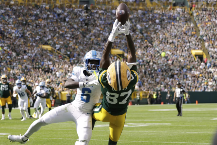 Green Bay Packers wide receiver Romeo Doubs (87) and Detroit Lions cornerback Terrion Arnold (6) show off their athleticism on Sept. 7, 2025. AP Photo/Matt Ludtke