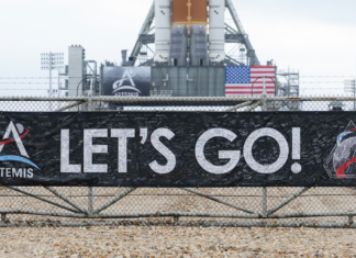 NASA’s Artemis II plans to send a crew around the Moon to test equipment and lay the groundwork for a future landing A banner signed by NASA employees and contractors outside Launch Complex 39B, where NASA’s Artemis II rocket is visible in the background. NASA/Joel Kowsky, CC BY-NC-ND