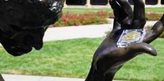 SEEGRAIN in the outstretched hand of Rodin's hero citizen of Calais is a monumental symbol of the mission to establish trust, good faith, and collaboration among all